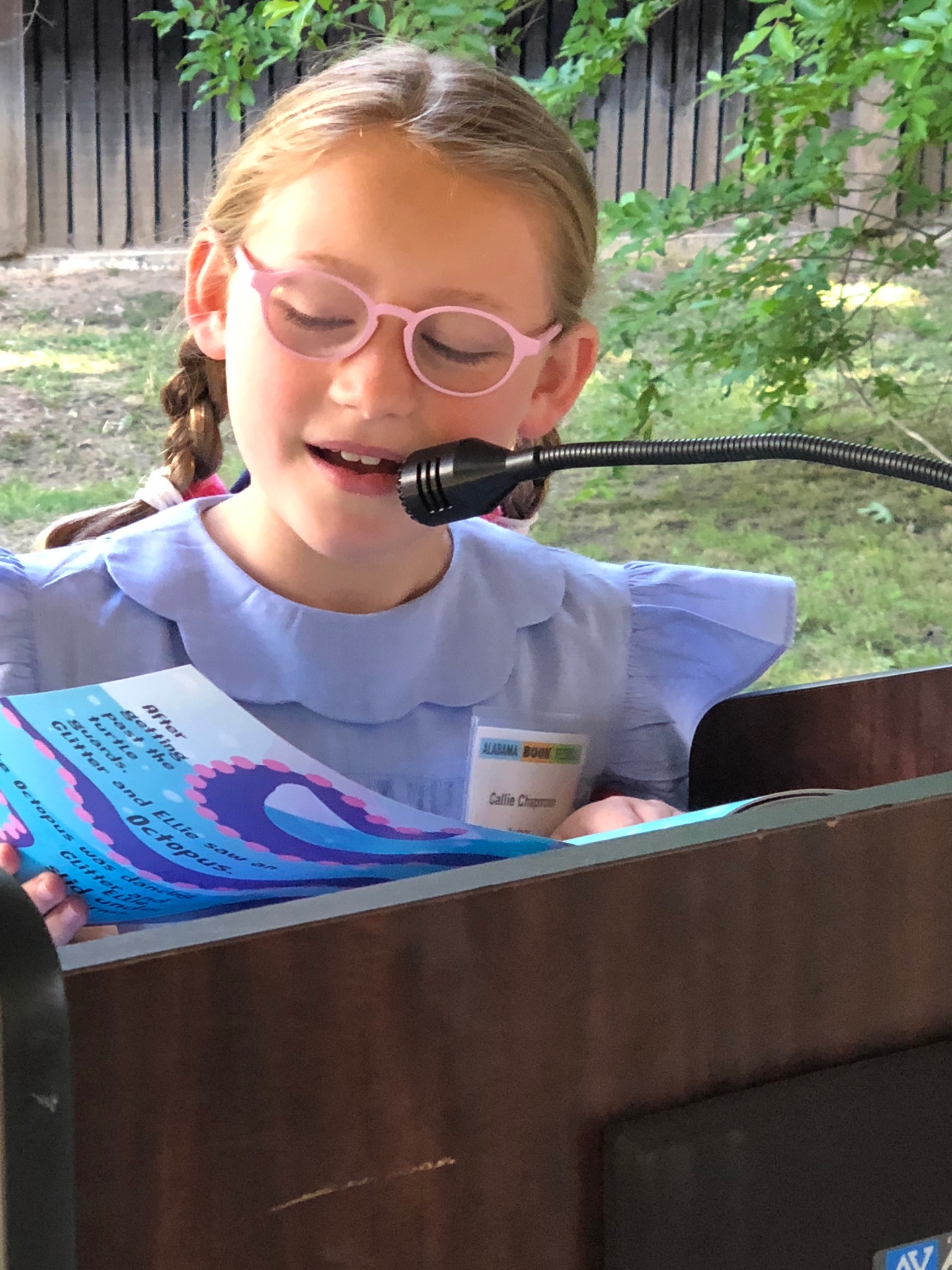 Reading at the podium with Callie Chapman name badge