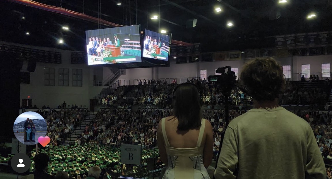 Callie Chapman behind the camera for Spartan 2 News, filming a Mountain Brook High School graduation ceremony